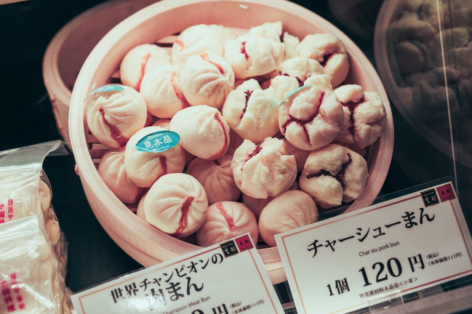 Delicious Japanese Char Siu pork buns displayed in a bamboo steamer with price tag.